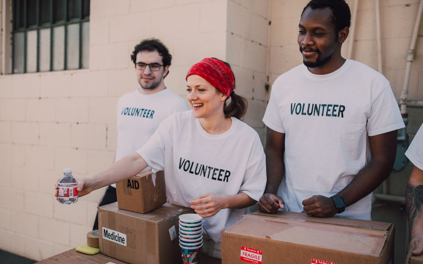 Support workers organising resources at a community table